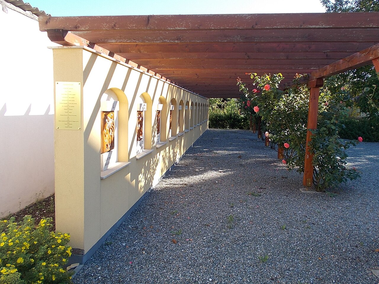 Pergola s drevenými trámami pri stene